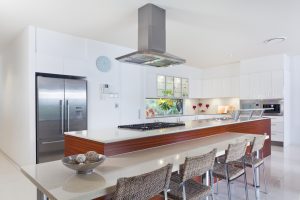 A modern kitchen with breakfast bar and stainless steel appliances