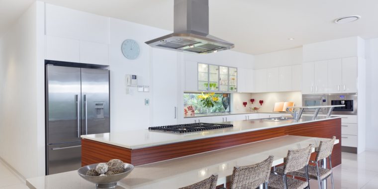 A modern kitchen with breakfast bar and stainless steel appliances