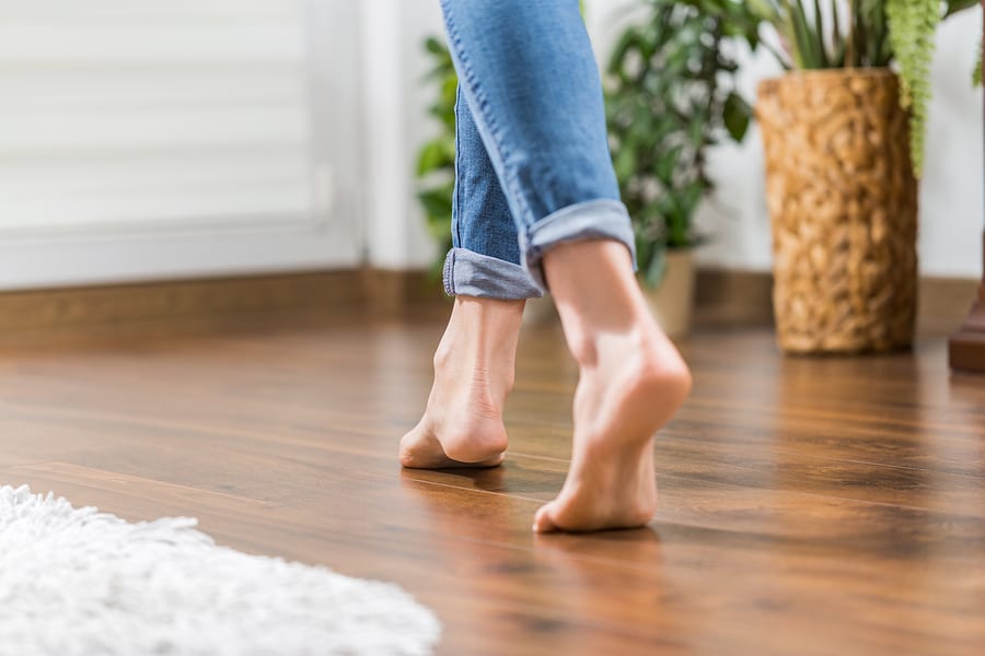 Young woman walking in the house on the warm floor.