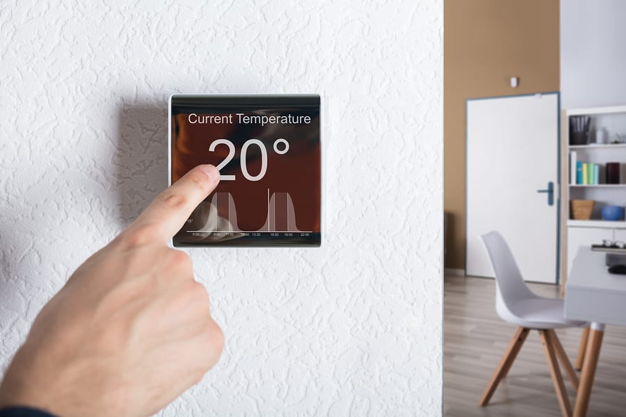 Finger Touching Digital Thermostat Temperature Controller At Home