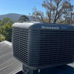 Breezair evaporative cooling unit on the roof of a house