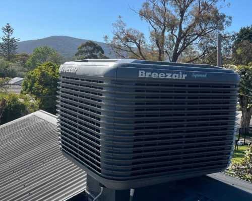 Breezair evaporative cooling unit on the roof of a house