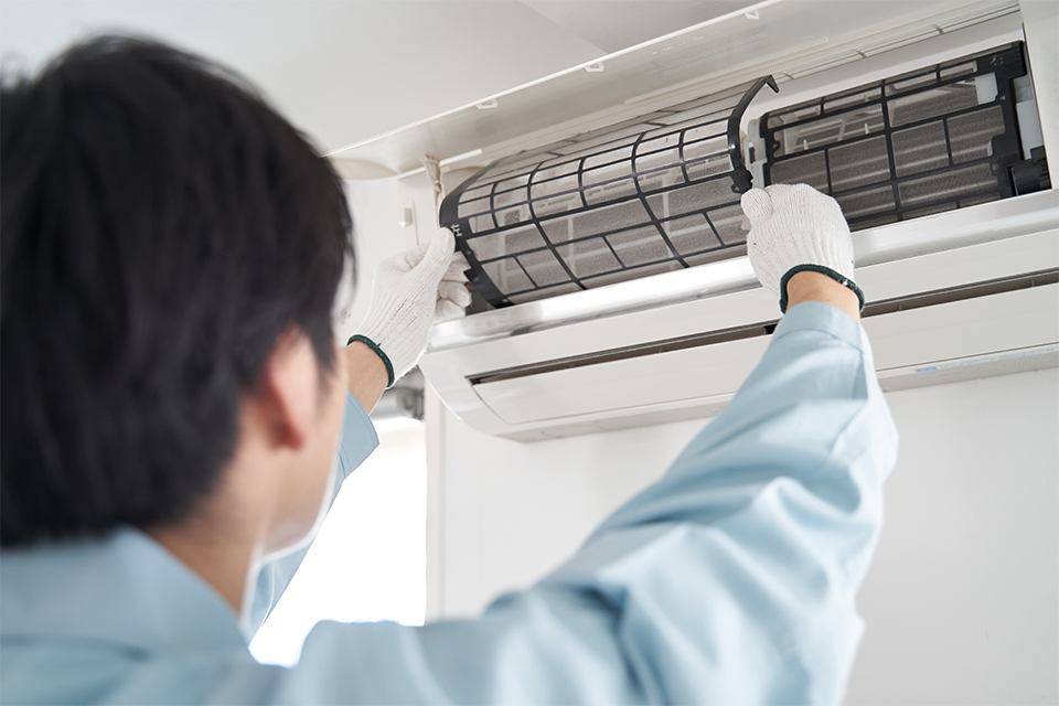 Man changing the filter in an air conditioner