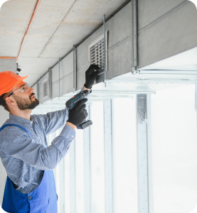 Man servicing air conditioning unit