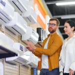 Young couple choosing between air conditioning units